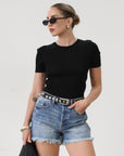 High-waisted faded and distressed denim shorts. Button and zipper fly closures. Five pocket construction. Frayed hem. True to size. Size up for a more relaxed look.