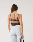 Floral printed woven cropped tank top. Adjustable straps. Boning in bodice. Elastic back strap with hook and eye closures. Back zipper closure. Fully lined.