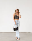 Floral printed woven cropped tank top. Adjustable straps. Boning in bodice. Elastic back strap with hook and eye closures. Back zipper closure. Fully lined.