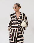 Printed woven shirt. Collar neckline. Long sleeves. Front button down closures. Side slits. Unlined. matching set. lounge set. throw on set. set for vacation.