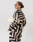 Printed woven shirt. Collar neckline. Long sleeves. Front button down closures. Side slits. Unlined. matching set. lounge set. throw on set. set for vacation.