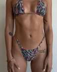 Tie dye crochet knit triangle bikini top. Ring details. Adjustable back tie closures with tassel details. Unlined. Bikini top. Crochet swimsuit
