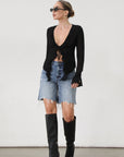 Faded and distressed denim bermuda shorts. Button and zipper fly. Five pocket construction. Frayed hem. Minimal stretch.