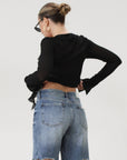Faded and distressed denim bermuda shorts. Button and zipper fly. Five pocket construction. Frayed hem. Minimal stretch.