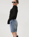 Faded and distressed denim bermuda shorts. Button and zipper fly. Five pocket construction. Frayed hem. Minimal stretch.