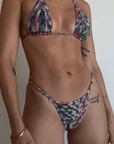 Tie dye crochet knit triangle bikini top. Ring details. Adjustable back tie closures with tassel details. Unlined. Bikini top. Crochet swimsuit