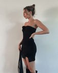Chenille knit dress. Elastic neckline. Rosette details. Front slits. Unlined. Black mini dress. Strapless dress. Mini side slit.
