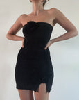 Chenille knit dress. Elastic neckline. Rosette details. Front slits. Unlined. Black mini dress. Strapless dress. Mini side slit.