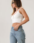 Knit crop tank. Fixed straps. Lace trim. Front tie detail. Back button down closures. Unlined. White tank top. Summer top.