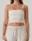 Ribbed knit tube top. Foldover elastic strapless neckline. Inner rubber grip lining. Unlined. Tube top. Ivory tube top. White tube top.