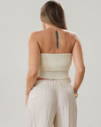Ribbed knit tube top. Foldover elastic strapless neckline. Inner rubber grip lining. Unlined. Tube top. Ivory tube top. White tube top.