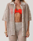 Open knit crochet shirt. Collar neckline. Short sleeves. Front button down closures. Unlined/sheer. Beach coverup. Pool coverup. Tan oat top
