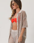 Open knit crochet shirt. Collar neckline. Short sleeves. Front button down closures. Unlined/sheer. Beach coverup. Pool coverup. Tan oat top