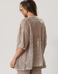 Open knit crochet shirt. Collar neckline. Short sleeves. Front button down closures. Unlined/sheer. Beach coverup. Pool coverup. Tan oat top