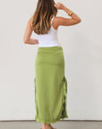 Satin maxi skirt. Side hook and eye and zipper closures. Side slits. Tie details. Lace trim. Fully lined. Green skirt.