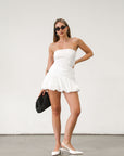 Eyelet woven tube top. Inner rubber grip lining. Side zipper closure. Fully lined. Strapless top. Eyelet tube top. White tube top. Summer top