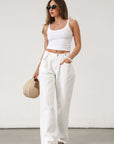 Wide leg jeans. Adjustable button waist closures. Button and zipper fly. Four pocket construction. Unlined. White jeans. White baggy jeans