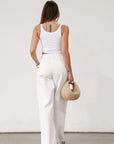 Wide leg jeans. Adjustable button waist closures. Button and zipper fly. Four pocket construction. Unlined. White jeans. White baggy jeans