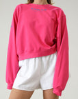 Graphic printed knit sweatshirt. Cropped fit. Unlined. Pink cropped oversized sweater. Airport outfit. Loungewear. Relaxing outfit.