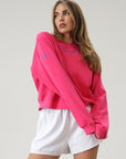 Graphic printed knit sweatshirt. Cropped fit. Unlined. Pink cropped oversized sweater. Airport outfit. Loungewear. Relaxing outfit.