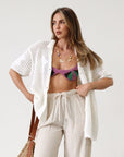 Open knit crochet shirt. Oversized fit. Collar neckline. Short sleeves. Front button down closures. Unlined. Beach shirt cover up. Pool shirt cover up. Vacation outfit. White crochet top.
