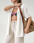 Open knit crochet shirt. Oversized fit. Collar neckline. Short sleeves. Front button down closures. Unlined. Beach shirt cover up. Pool shirt cover up. Vacation outfit. White crochet top.
