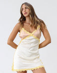 Satin dress. Lace trim. Adjustable straps. Back hook and eye and zipper closures. Unlined. Silk slip dress. Yellow slip dress. Slip dress with lace. Sexy dress. Yellow mini dress.
