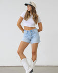 Relaxed high rise vintage shorts. Button fly closure. Distressed. Unlined. No stretch. light wash denim shorts. frayed shorts. mid to high rise shorts