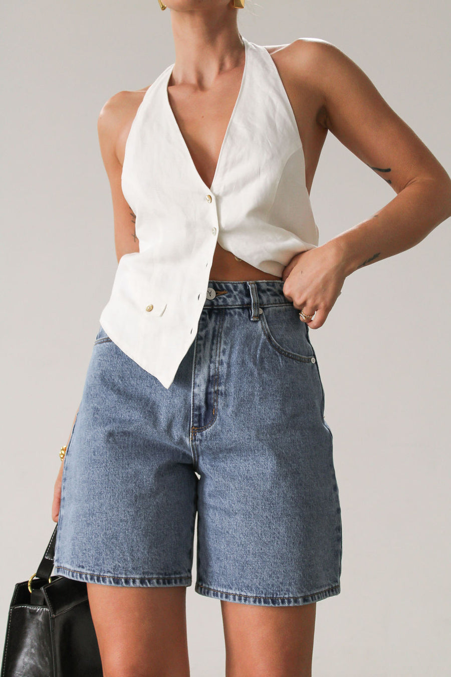 Denim shorts. Button and zipper fly closure. Five pockets. Unlined. High waisted, relaxed, wide leg, mid thigh length, non-stretch rigid denim.