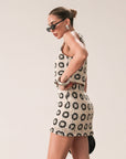 TOP: Crochet crop top. Sleeveless. Front tie closure. Fully lined. BOTTOM: Crochet skirt. Elastic waist. Side hook and eye and zipper closures. Fully lined. Ivory with black detail.