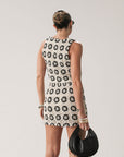 TOP: Crochet crop top. Sleeveless. Front tie closure. Fully lined. BOTTOM: Crochet skirt. Elastic waist. Side hook and eye and zipper closures. Fully lined. Ivory with black detail.