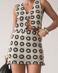 TOP: Crochet crop top. Sleeveless. Front tie closure. Fully lined. BOTTOM: Crochet skirt. Elastic waist. Side hook and eye and zipper closures. Fully lined. Ivory with black detail.
