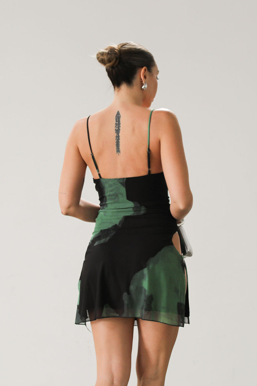Printed knit mesh dress. Adjustable straps. Side slits with silver ring details. Fully lined. Green and black. Square neckline. 