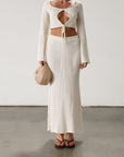 Cream maxi skirt set with long sleeve crop top.TOP: Textured crochet knit crop top. Long bell sleeves. Front keyhole and tie closure. Unlined BOTTOM: Textured crochet knit maxi skirt. Elastic waist. Unlined.