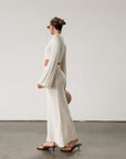 Cream maxi skirt set with long sleeve crop top.TOP: Textured crochet knit crop top. Long bell sleeves. Front keyhole and tie closure. Unlined BOTTOM: Textured crochet knit maxi skirt. Elastic waist. Unlined.