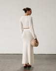 Cream maxi skirt set with long sleeve crop top.TOP: Textured crochet knit crop top. Long bell sleeves. Front keyhole and tie closure. Unlined BOTTOM: Textured crochet knit maxi skirt. Elastic waist. Unlined.