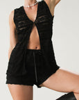 Ruffled knit lace shorts. Elastic waist. Front tie detail. Fully lined.