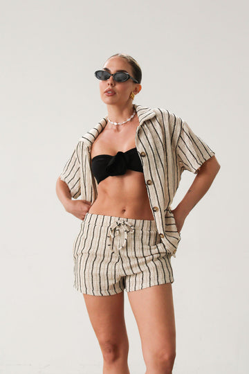 TOP: Striped textured shirt. Collar neckline. Short sleeves. Front button down closure. Unlined.&nbsp;   BOTTOM: Striped textured shorts. Elastic waist with drawstring closure. Side pockets. Fully lined. Ivory with black stripes. Tortoise buttons.  