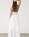 Crinkle woven maxi dress. Adjustable halter tie neck. Elastic smocked waist. Elastic back. Back cut out. Fully lined. White maxi dress. White halter neck dress. Summer dress. dress to wear on vacation. flowy dress. deep v neck dress. European summer outfit