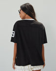 Mesh jersey t-shirt. V-neckline. Short sleeves. Side slits. Unlined/sheer. black jersey top. sporty casual outfit. summer top