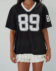 Mesh jersey t-shirt. V-neckline. Short sleeves. Side slits. Unlined/sheer. black jersey top. sporty casual outfit. summer top