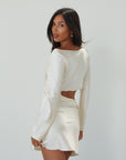 Satin dress. Long sleeves. Side cut out. Side zipper closure. Unlined. off white satin dress. off white mini dress. dress with cut out. cream satin mini dress. bride. bridal dress. engagement dress. bridal shower dress. wedding after party dress