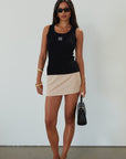 Woven mini skort. Side hook and eye and zipper closures. Back pockets. Shorts lining. mini skort. beige skort. tan skort. summer skort.