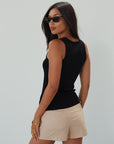 Woven mini skort. Side hook and eye and zipper closures. Back pockets. Shorts lining. mini skort. beige skort. tan skort. summer skort.