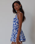 Printed woven dress. Adjustable cross rods back straps with tie closure. Back hook and eye and zipper closures. Fully lined. blue and white floral mini dress. summer dress. greece inspired dress. garden party dress. wedding guest dress.