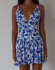 Printed woven dress. Adjustable cross rods back straps with tie closure. Back hook and eye and zipper closures. Fully lined. blue and white floral mini dress. summer dress. greece inspired dress. garden party dress. wedding guest dress.