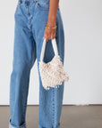 Small beaded bag. Fixed top strap. Top snap button closure. Fully lined. 