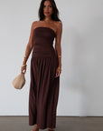 Knit maxi dress. Strapless elastic neckline. Inner rubber grip lining. Ruched slides. Partially lined. brown maxi dress. brown starpless maxi dress. summer dress. wedding guest dress