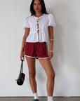 Satin shorts. Elastic waist. Side pockets. Unlined. cute track shorts. fashion track short. red shorts. red track shorts.