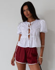 Satin shorts. Elastic waist. Side pockets. Unlined. cute track shorts. fashion track short. red shorts. red track shorts.